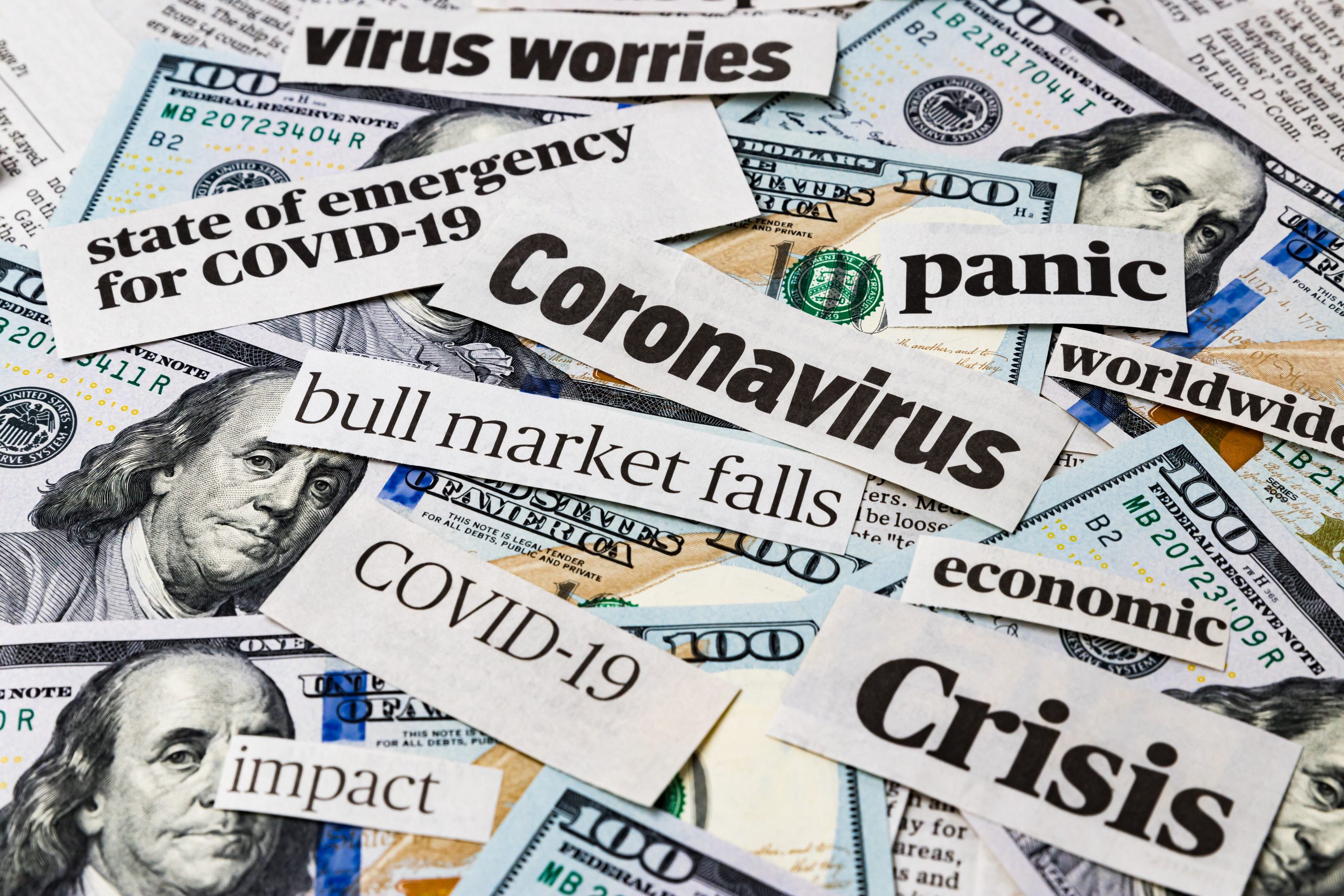 Coronavirus, covid-19 news headlines on United States of America 100 dollar bills. Concept of financial impact, stock market decline and crash due to worldwide pandemic